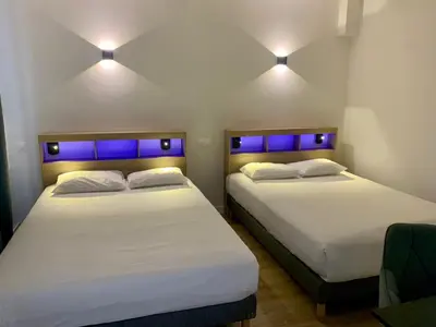 Un ou plusieurs lits dans un hébergement de l'établissement Hôtel de Paris - Dijon Centre Gare