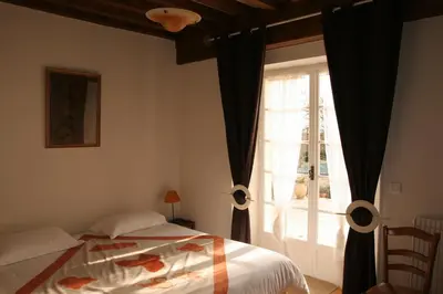 Un ou plusieurs lits dans un hébergement de l'établissement Maison d'hôtes Fleurs de Vignes