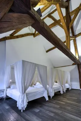 Un ou plusieurs lits dans un hébergement de l'établissement La Maison Blanche