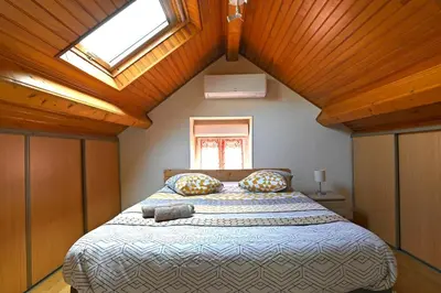 Un ou plusieurs lits dans un hébergement de l'établissement La Petite Maison Blanzy