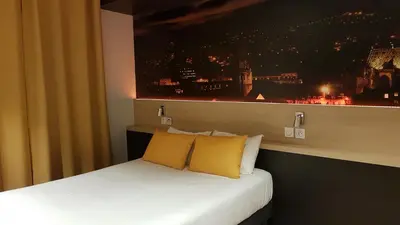 Un ou plusieurs lits dans un hébergement de l'établissement Appart Hotel Montchapet Dijon Centre