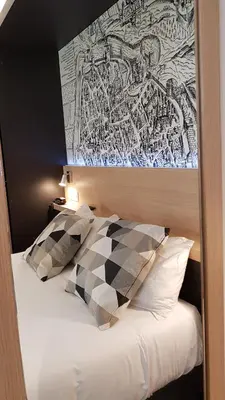 Un ou plusieurs lits dans un hébergement de l'établissement Appart Hotel Montchapet Dijon Centre