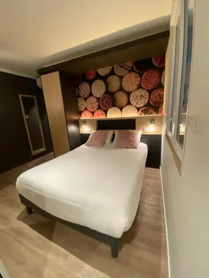 Un ou plusieurs lits dans un hébergement de l'établissement Appart Hotel Montchapet Dijon Centre