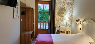 Un ou plusieurs lits dans un hébergement de l'établissement Hotel Village Motel