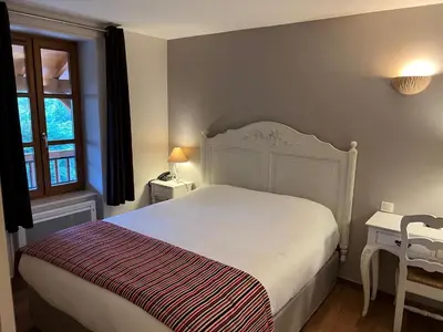 Un ou plusieurs lits dans un hébergement de l'établissement Hotel Village Motel