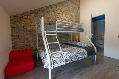 Un ou plusieurs lits dans un hébergement de l'établissement Gîte L'Atelier de Tournerie