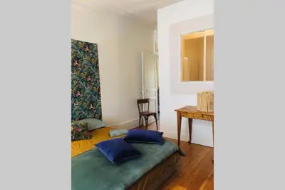 Un ou plusieurs lits dans un hébergement de l'établissement Chez Angèle Centre Mâcon appartement chaleureux