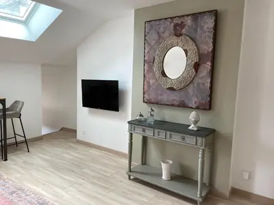 Télévision ou salle de divertissement dans l'établissement Au coin des Hospices