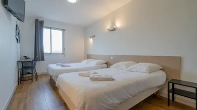 Un ou plusieurs lits dans un hébergement de l'établissement Hôtel Des Docks