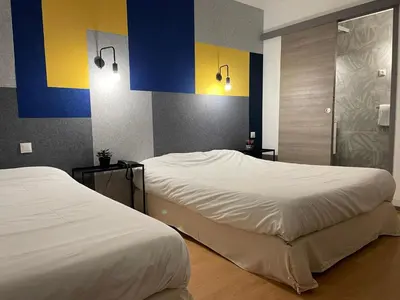 Un ou plusieurs lits dans un hébergement de l'établissement Brit Hotel Dijon Centre Gare