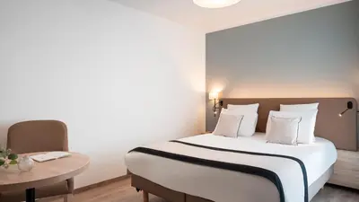 Un ou plusieurs lits dans un hébergement de l'établissement Residhome Dijon Cité Des Vignes