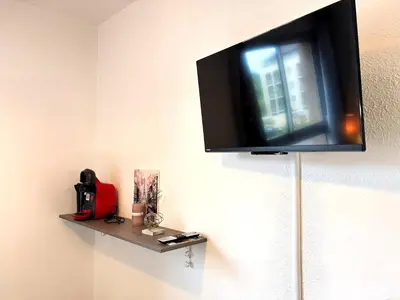 Télévision ou salle de divertissement dans l'établissement Les Logis de Paray Appartement 202