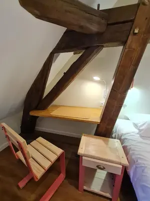 Un ou plusieurs lits dans un hébergement de l'établissement Le Faubourg - Gîte et chambres d'hôte