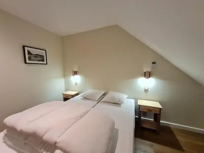 Un ou plusieurs lits dans un hébergement de l'établissement Le Faubourg - Gîte et chambres d'hôte