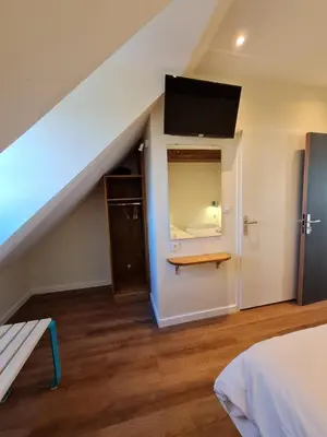 Un ou plusieurs lits dans un hébergement de l'établissement Le Faubourg - Gîte et chambres d'hôte