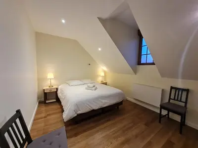 Un ou plusieurs lits dans un hébergement de l'établissement Le Faubourg - Gîte et chambres d'hôte