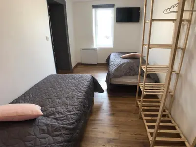 Un ou plusieurs lits dans un hébergement de l'établissement Gîte Raisin Rose