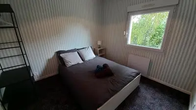 Un ou plusieurs lits dans un hébergement de l'établissement Studio Privé Dijon