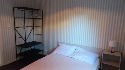 Un ou plusieurs lits dans un hébergement de l'établissement Studio Privé Dijon