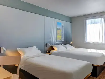 Un ou plusieurs lits dans un hébergement de l'établissement B&B HOTEL Le Creusot Montchanin