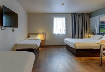Un ou plusieurs lits dans un hébergement de l'établissement B&B HOTEL Le Creusot Montchanin