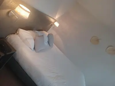 Un ou plusieurs lits dans un hébergement de l'établissement Hôtel La Parenthèse