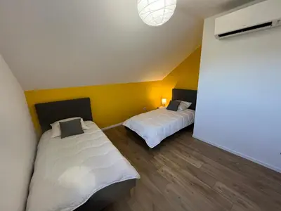Un ou plusieurs lits dans un hébergement de l'établissement SCI BSA Magnifique maison au calme
