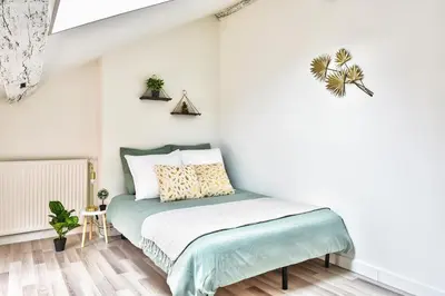 Un ou plusieurs lits dans un hébergement de l'établissement Appartement Le Chaleureux Chalon - Hyper-Centre