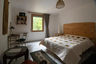 Un ou plusieurs lits dans un hébergement de l'établissement Chambre indépendante dans le moulin